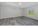 Main bedroom with wood-look tile floors, high ceilings, and large window at 113 Glades Dr, Rotonda West, FL 33947