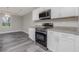 Modern kitchen with white cabinets, granite countertops, and stainless steel appliances at 450 Albatross Rd, Rotonda West, FL 33947