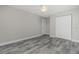Bedroom with double door closet and wood-look tile floors at 450 Albatross Rd, Rotonda West, FL 33947