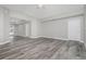Spacious living room with vaulted ceiling and wood-look tile floors at 450 Albatross Rd, Rotonda West, FL 33947