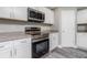 Kitchen features stainless steel appliances and white shaker cabinets at 450 Albatross Rd, Rotonda West, FL 33947