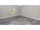 Spacious bedroom with wood-look tile flooring and a window at 450 Albatross Rd, Rotonda West, FL 33947