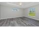 Spacious bedroom with large windows and gray tile floors at 450 Albatross Rd, Rotonda West, FL 33947
