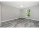 Bright bedroom with ceiling fan and wood-look tile floor at 450 Albatross Rd, Rotonda West, FL 33947