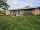 House with overgrown yard and unkempt landscaping at 11290 6Th Ave, Punta Gorda, FL 33955