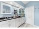 Bright bathroom with double vanity, dark countertop, and white cabinets at 15490 Mccomb Cir, Port Charlotte, FL 33981