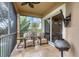 Relaxing screened balcony with patio furniture and lake views at 10311 Lands End Cir # 13, Placida, FL 33946