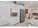 Modern kitchen with white cabinets and granite countertops at 10311 Lands End Cir # 13, Placida, FL 33946