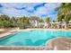 Resort-style swimming pool with lounge chairs and patio at 10311 Lands End Cir # 13, Placida, FL 33946