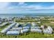Aerial view of waterfront community with lake, pool, and numerous townhouses at 10311 Lands End Cir # 13, Placida, FL 33946