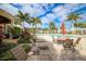 Relaxing pool area with patio furniture and palm trees at 10311 Lands End Cir # 13, Placida, FL 33946