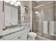 Bathroom with granite countertop, walk-in shower, and modern fixtures at 10311 Lands End Cir # 13, Placida, FL 33946