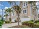 Tan three-story home with attached garage and lush landscaping at 10311 Lands End Cir # 13, Placida, FL 33946