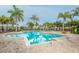 Inviting community pool with lounge chairs and palm trees at 10311 Lands End Cir # 13, Placida, FL 33946