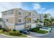 Tan three-story townhouse with attached garage and landscaping at 10311 Lands End Cir # 13, Placida, FL 33946