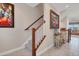 Elegant staircase with wooden handrail and artwork at 10311 Lands End Cir # 13, Placida, FL 33946