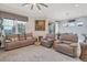 Spacious living room with leather furniture and large windows at 10311 Lands End Cir # 13, Placida, FL 33946