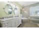 Elegant bathroom with double vanity, soaking tub, and walk-in shower at 265 White Marsh Ln, Rotonda West, FL 33947