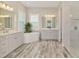 Bathroom with double vanity, soaking tub, and walk-in shower at 12424 Davie Ct, Venice, FL 34293