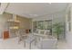 Outdoor kitchen with stainless steel appliances and seating area at 12424 Davie Ct, Venice, FL 34293