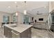 Open concept kitchen with large island, stainless steel appliances and view into living room at 12424 Davie Ct, Venice, FL 34293