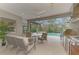 Outdoor kitchen with stainless steel appliances and seating area at 12424 Davie Ct, Venice, FL 34293