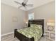Guest bedroom with ceiling fan, tropical bedding, and two nightstands at 12424 Davie Ct, Venice, FL 34293