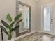 Bright entryway with large mirror and stylish flooring at 12424 Davie Ct, Venice, FL 34293