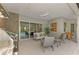 Covered outdoor kitchen with seating and pool view at 12424 Davie Ct, Venice, FL 34293