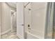 Bathroom with bathtub, shower, and light blue shower curtain at 12424 Davie Ct, Venice, FL 34293