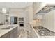Modern kitchen with gray cabinets, marble countertops, and stainless steel appliances at 12424 Davie Ct, Venice, FL 34293