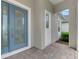 Front view of the house with a blue door and brick walkway at 12424 Davie Ct, Venice, FL 34293
