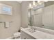 Bathroom with vanity, toilet, shower, and gray quartz countertop at 12424 Davie Ct, Venice, FL 34293
