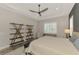 Main bedroom with wood shelving and a ceiling fan at 12424 Davie Ct, Venice, FL 34293
