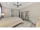 Main bedroom with wood shelving and a ceiling fan at 12424 Davie Ct, Venice, FL 34293