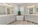 Bathroom with double vanity, soaking tub, and walk-in shower at 12424 Davie Ct, Venice, FL 34293