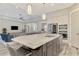Open concept kitchen with a large marble island and stainless steel appliances at 12424 Davie Ct, Venice, FL 34293