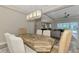 Open concept dining room with a large wood table and views into the living area and kitchen at 12424 Davie Ct, Venice, FL 34293