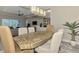 Elegant dining room features a unique wood table, stylish chairs, and a modern chandelier at 12424 Davie Ct, Venice, FL 34293