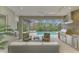 Modern outdoor kitchen with stainless steel appliances and seating area at 12424 Davie Ct, Venice, FL 34293