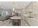 Open concept kitchen with gray cabinets, marble island, and stainless steel appliances at 12424 Davie Ct, Venice, FL 34293