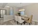 Elegant dining room featuring a wood table and neutral colored chairs at 12424 Davie Ct, Venice, FL 34293