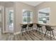 Breakfast nook with wooden countertop and built-in seating overlooking the pool at 12424 Davie Ct, Venice, FL 34293