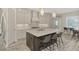 Modern kitchen with gray cabinets, marble countertops, and stainless steel appliances at 12424 Davie Ct, Venice, FL 34293