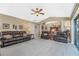 Spacious Gathering room with leather reclining sofas and a view into the kitchen and dining areas at 15658 Stuart Cir, Port Charlotte, FL 33981