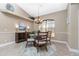Bright dining room with a round table and four chairs, complemented by a chandelier and neutral wall tones at 15658 Stuart Cir, Port Charlotte, FL 33981