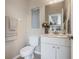 Clean bathroom with white vanity, toilet, and decorative accents at 15658 Stuart Cir, Port Charlotte, FL 33981