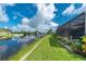 Landscaped backyard with canal views and dock at 15658 Stuart Cir, Port Charlotte, FL 33981