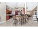 Modern kitchen with rich wood cabinets, granite countertops, and a breakfast bar at 15658 Stuart Cir, Port Charlotte, FL 33981