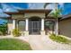Front view of the house with columns and landscaping at 15658 Stuart Cir, Port Charlotte, FL 33981